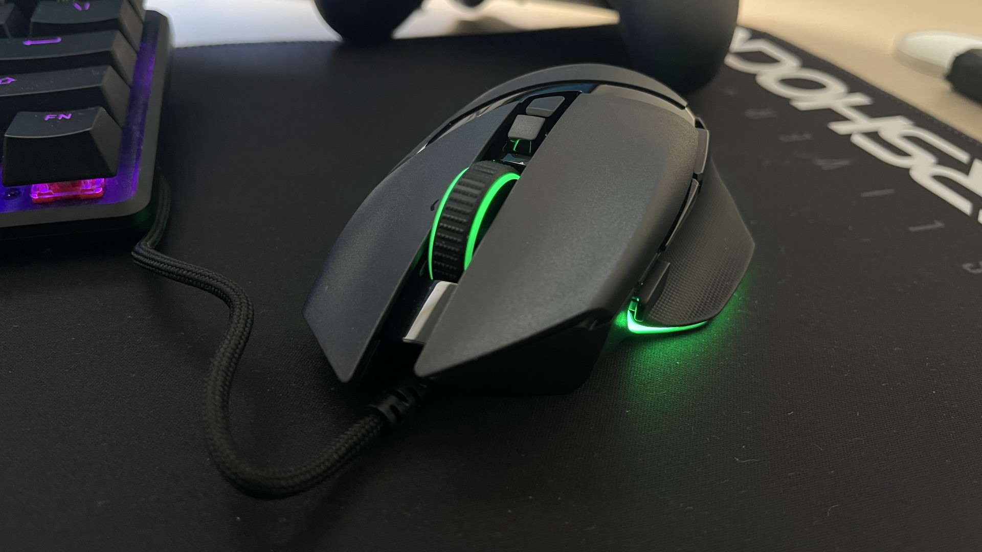 Razer Basilisk V3 gaming mouse from the front on a black mouse mat